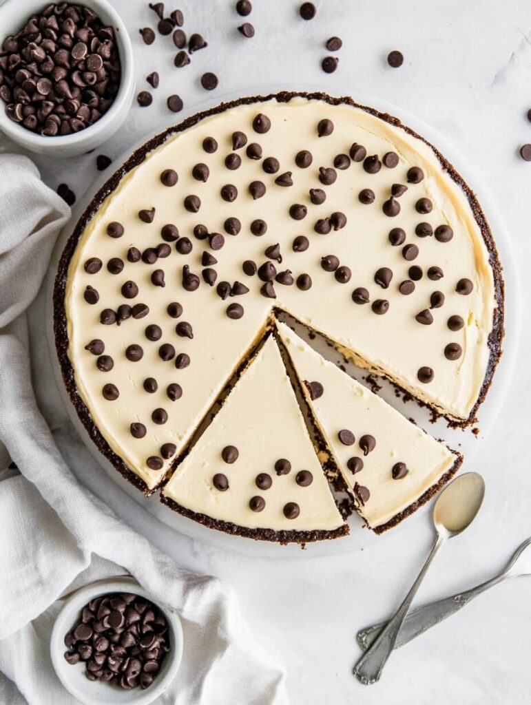 Top-down view of cheesecake with chocolate chips on white marble